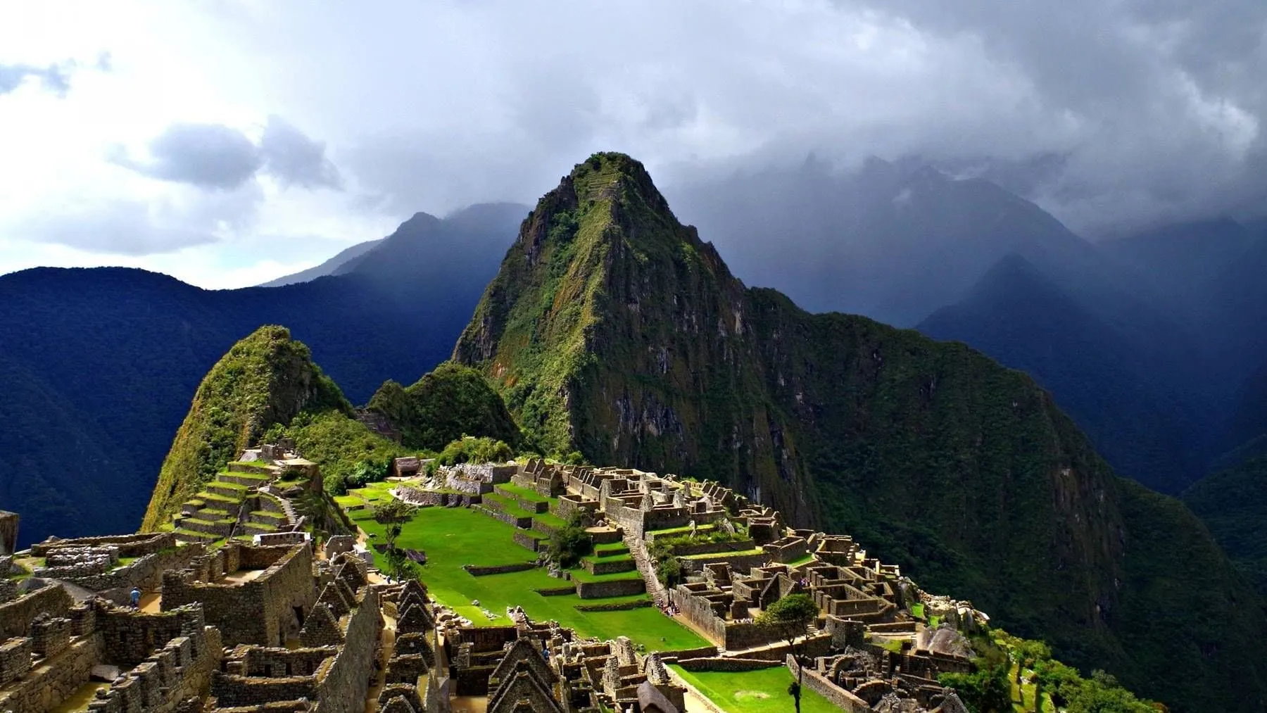 Tourist showing Machu Picchu ticket in front of the Inca citadel