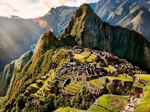 Different types of Machu Picchu entry tickets displayed with scenic ruins in the background